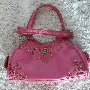 Gently used dark pink mountain west handbag.